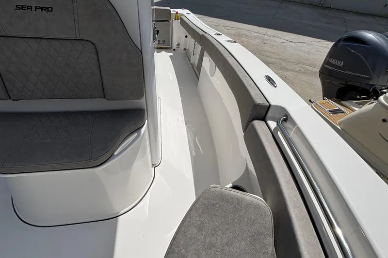 Slide: The Image of 2023 Sea Pro 239 Deep V CC boat interior with seating and Yamaha engine. - 17