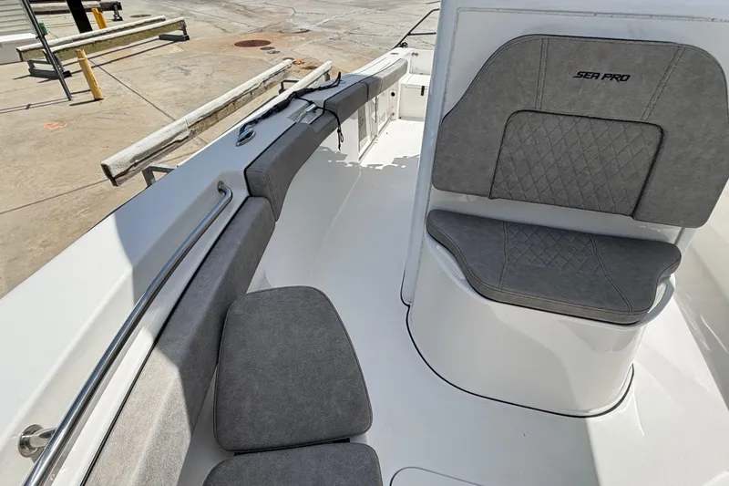 Slide: The Image of 2023 Sea Pro 239 Deep V CC boat interior with gray cushioned seating. - 18