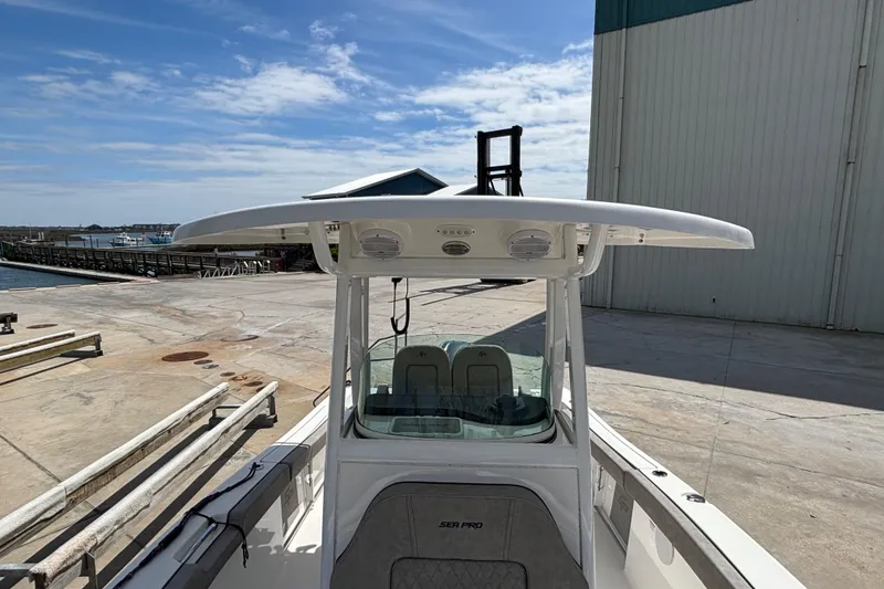 Slide: The Image of 2023 Sea Pro 239 Deep V CC boat docked at marina under clear sky. - 19