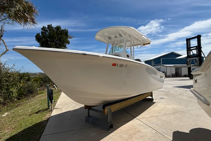 Slide: The Image of 2023 Sea Pro 239 Deep V CC boat on display under a clear blue sky. - 24