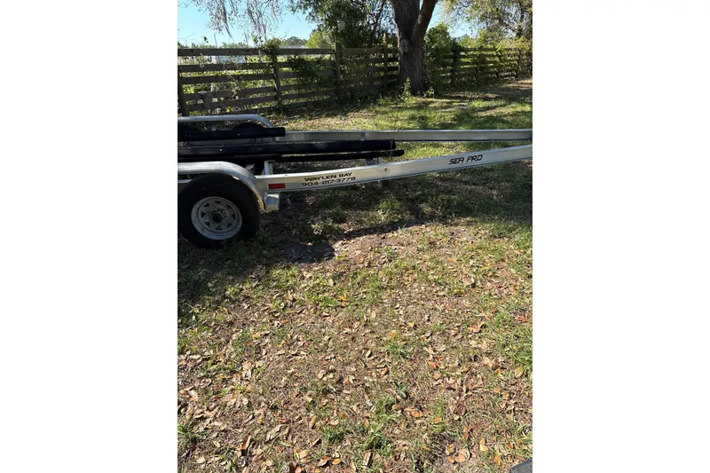 Slide: The Image of Trailer for 2023 Sea Pro 239 Deep V CC boat on grassy area. - 29