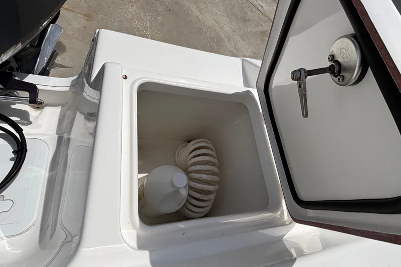 Slide: The Image of Storage compartment on 2023 Sea Pro 239 Deep V CC boat with rope and bottle. - 8