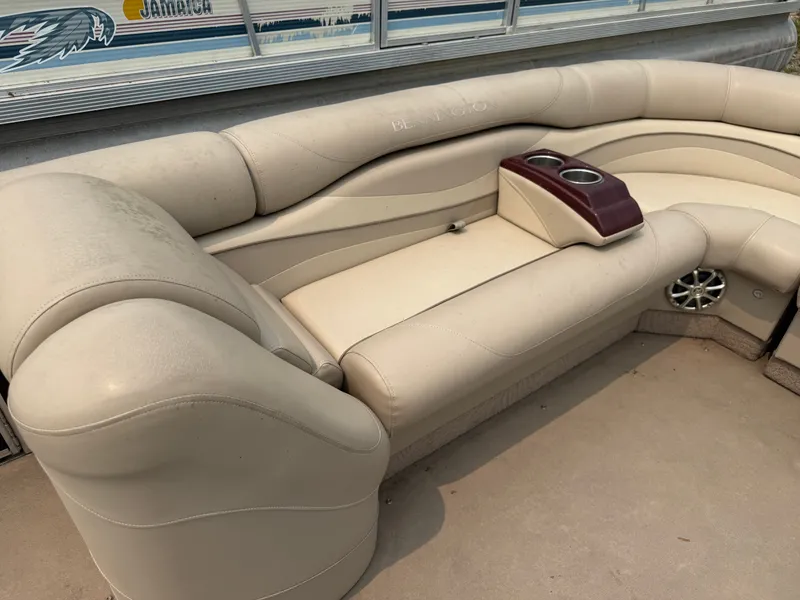 Slide: The Image of The image shows a cream-colored seating area on a boat with cup holders and speakers. - 11