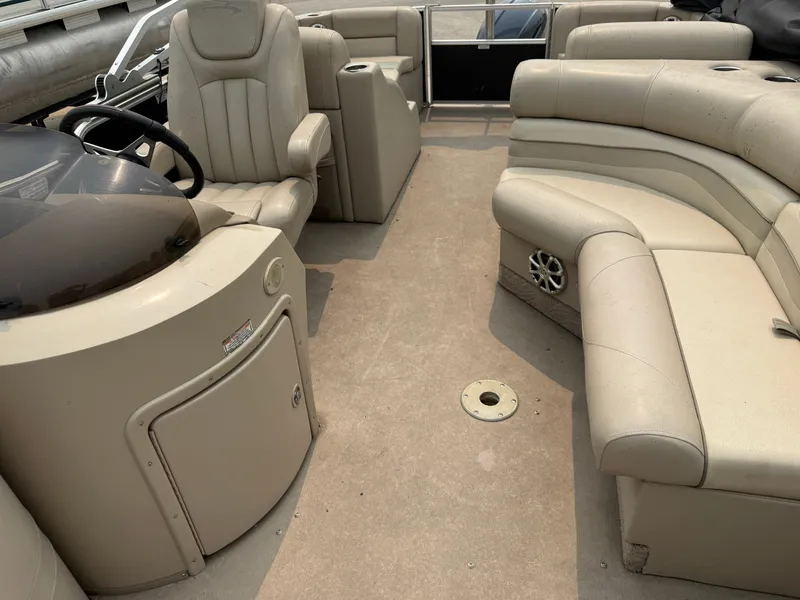 Slide: The Image of The image shows the interior of a 2010 Bennington 2550 RCW with beige leather seating. - 6