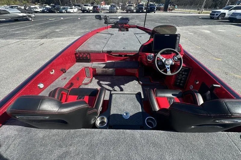 Slide: The Image of 2026 Phoenix 20 XE boat interior with red and black seating, steering wheel, and dashboard. - 11