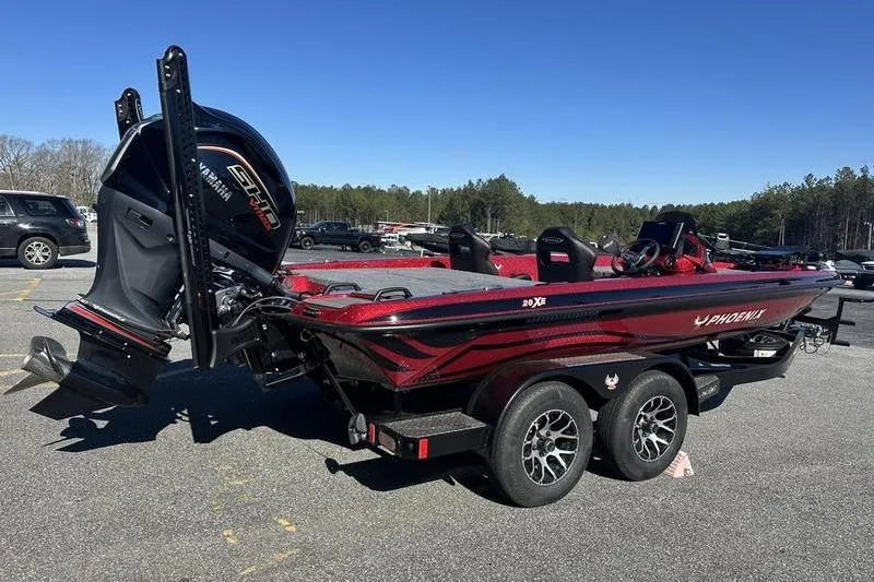 Slide: The Image of 2026 Phoenix 20 XE boat with Yamaha engine on a trailer in a parking lot. - 2