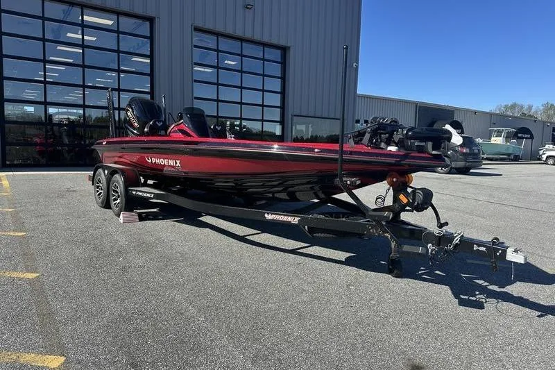Slide: The Image of 2026 Phoenix 20 XE boat on trailer in parking lot, near industrial building. - 8