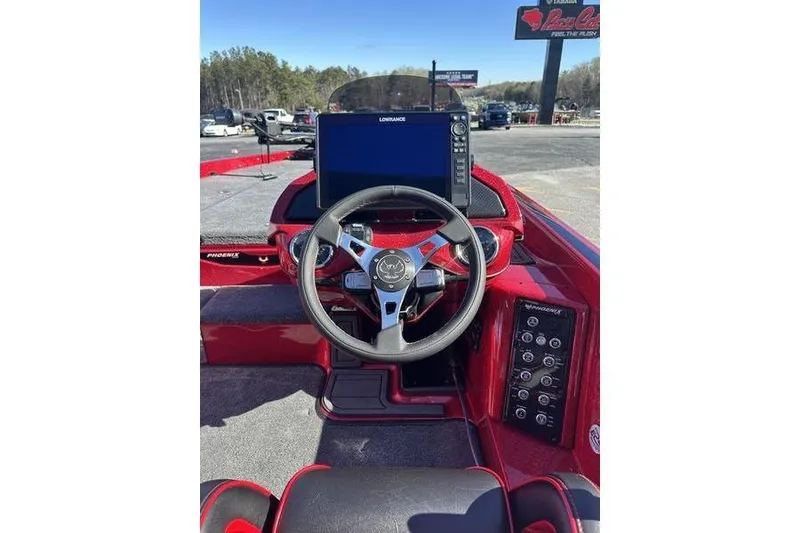 Slide: The Image of 2026 Phoenix 20 XE boat dashboard with steering wheel and navigation display. - 9