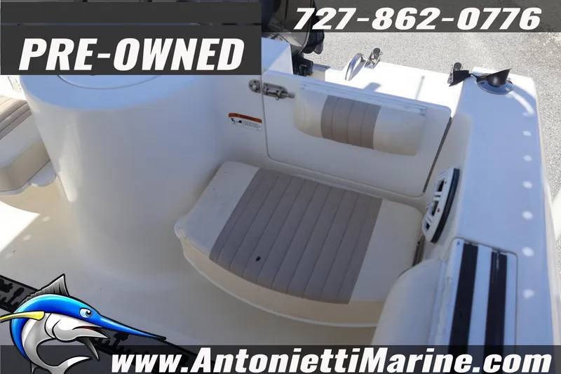 Slide: The Image of Pre-owned 2004 Aquasport 205 Osprey boat interior with seating, Antonietti Marine contact details. - 14
