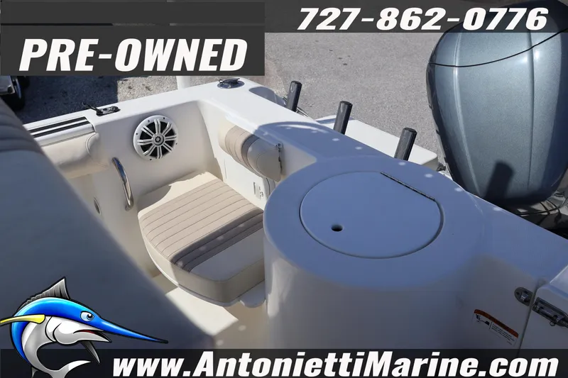 Slide: The Image of Pre-owned 2004 Aquasport 205 Osprey boat interior with seating and motor. - 15