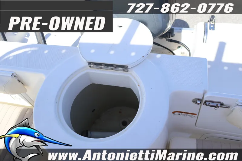 Slide: The Image of Pre-owned 2004 Aquasport 205 Osprey boat interior with storage compartment, contact Antonietti Marine. - 16