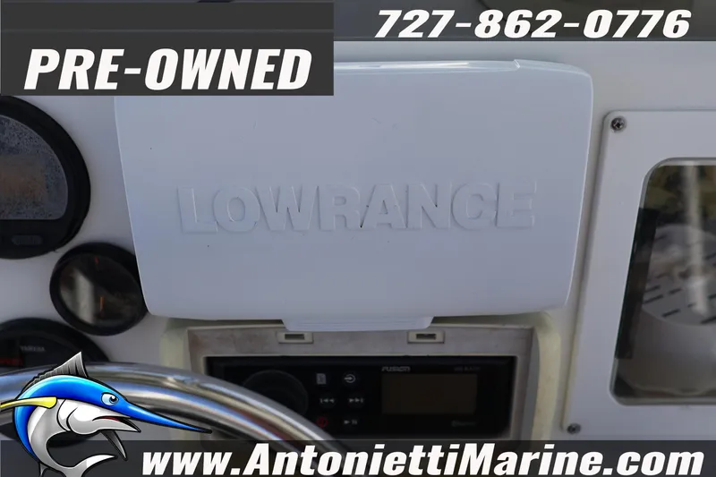 Slide: The Image of Pre-owned 2004 Aquasport 205 Osprey dashboard with Lowrance equipment, contact Antonietti Marine. - 19