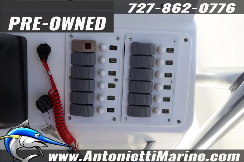 Slide: The Image of Control panel of a 2004 Aquasport 205 Osprey boat, pre-owned, with contact details. - 20