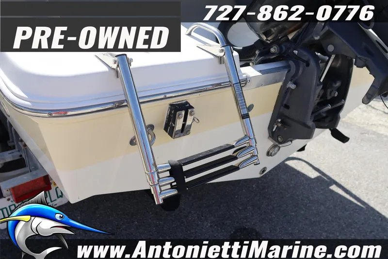 Slide: The Image of Pre-owned 2004 Aquasport 205 Osprey boat with ladder and contact information displayed. - 7
