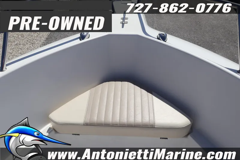 Slide: The Image of Pre-owned 2004 Aquasport 205 Osprey boat interior with cushioned seating. - 9