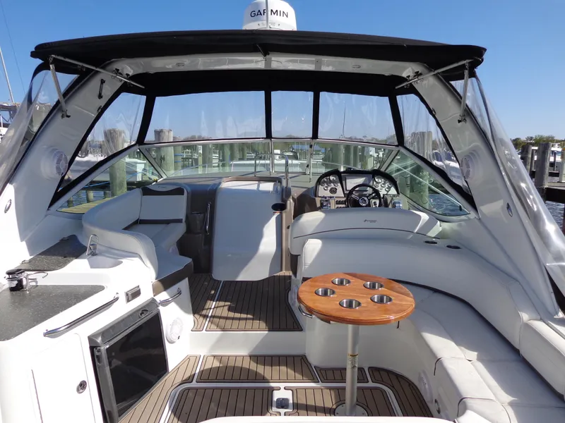 Slide: The Image of 2008 Cruisers Yachts 330 Express interior with seating, table, and helm. - 1