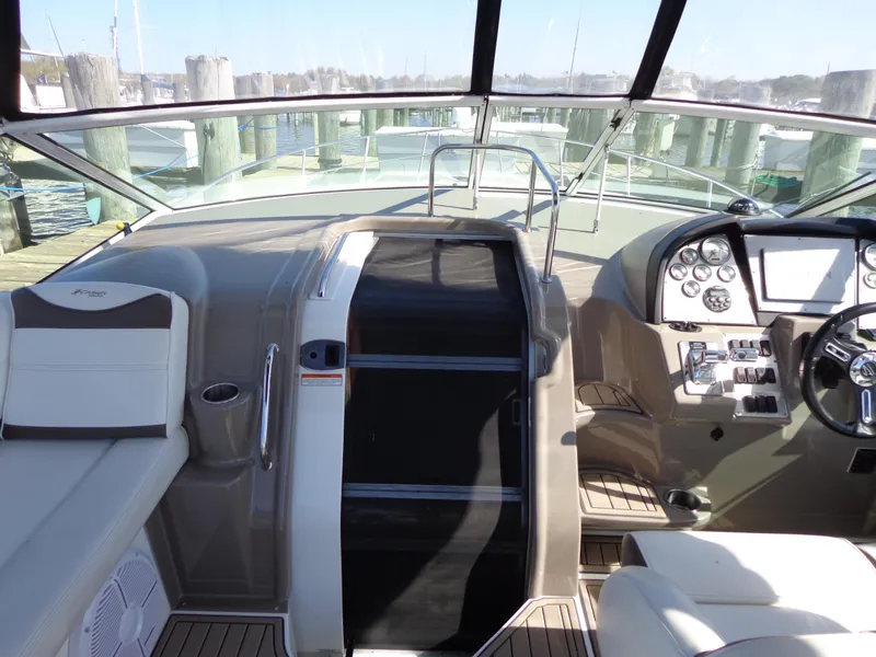 Slide: The Image of 2008 Cruisers Yachts 330 Express cockpit with helm, seating, and control panel. - 11