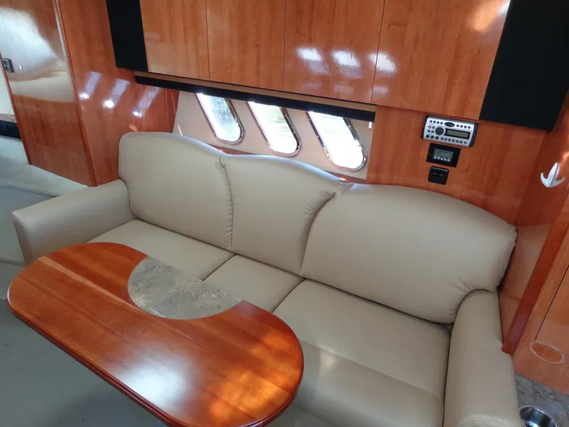 Slide: The Image of Luxurious interior of 2008 Cruisers Yachts 330 Express with beige sofa and wooden table. - 13
