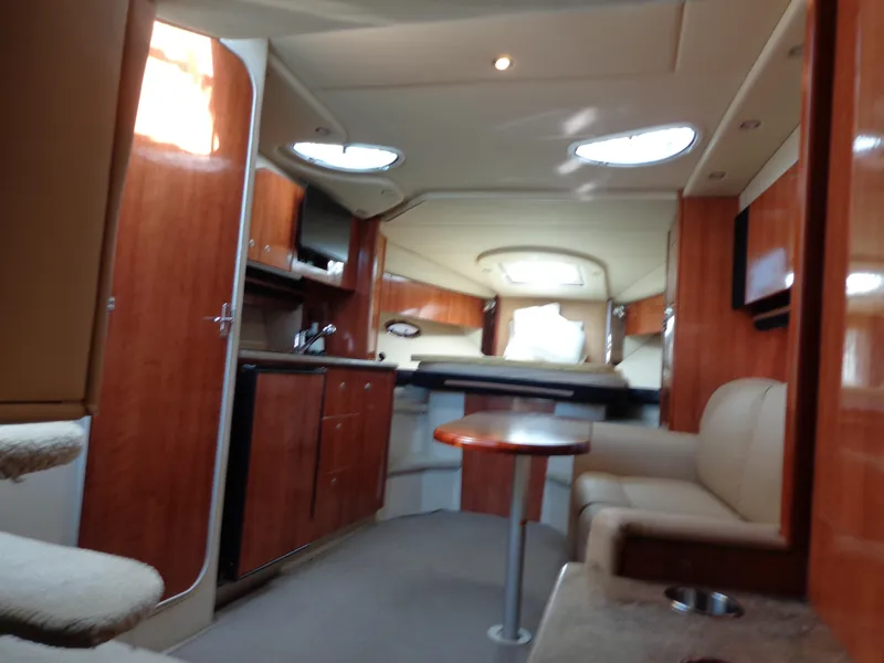 Slide: The Image of Luxurious interior of 2008 Cruisers Yachts 330 Express with wood finish and cozy seating. - 18