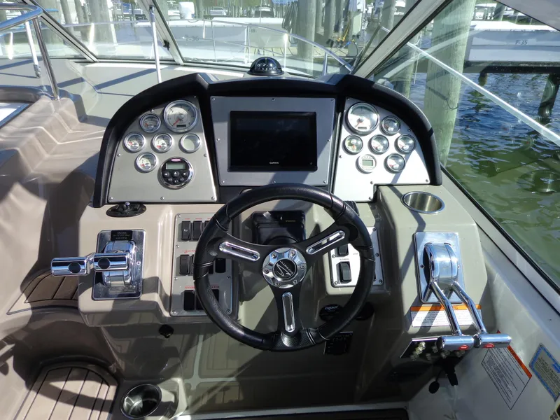 Slide: The Image of 2008 Cruisers Yachts 330 Express helm with steering wheel and control panel. - 6