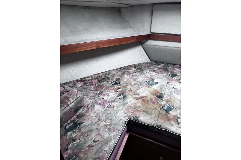 Slide: The Image of 1996 Bayliner 3388 Command Bridge Motoryacht cabin with floral-patterned bedding. - 11