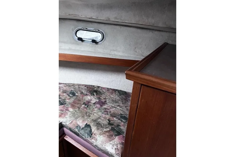 Slide: The Image of Interior cabin of 1996 Bayliner 3388 Command Bridge Motoryacht with patterned bedding and wooden cabinetry. - 12