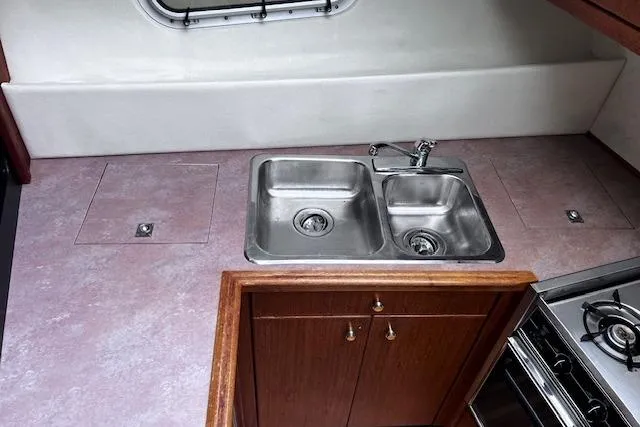 Slide: The Image of 1996 Bayliner 3388 Command Bridge Motoryacht kitchen with dual sinks and stove. - 15
