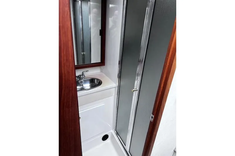 Slide: The Image of Bathroom interior of 1996 Bayliner 3388 Command Bridge Motoryacht with sink and shower. - 17