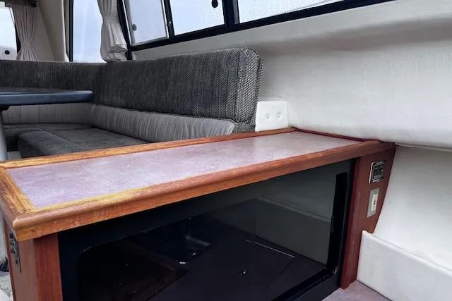 Slide: The Image of Interior of 1996 Bayliner 3388 Command Bridge Motoryacht with seating and wooden cabinetry. - 18