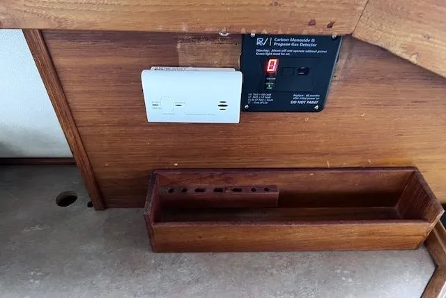 Slide: The Image of 1996 Bayliner 3388 Command Bridge Motoryacht interior with gas detector and wooden shelf. - 19