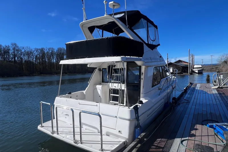 Slide: The Image of 1996 Bayliner 3388 Command Bridge Motoryacht docked on a sunny day. - 2