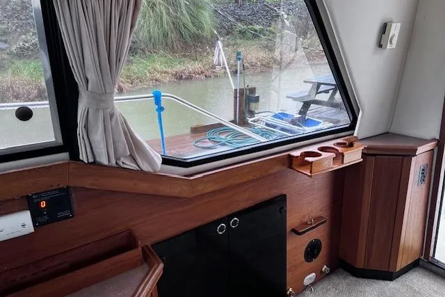 Slide: The Image of Interior view of 1996 Bayliner 3388 Command Bridge Motoryacht with wood paneling and window. - 22