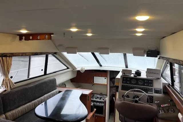 Slide: The Image of Interior of 1996 Bayliner 3388 Command Bridge Motoryacht with helm, seating, and navigation equipment. - 23