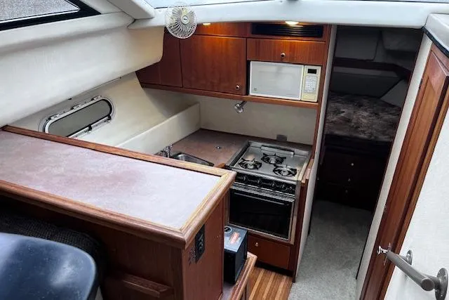 Slide: The Image of Interior of 1996 Bayliner 3388 Command Bridge Motoryacht with kitchen and sleeping area. - 24