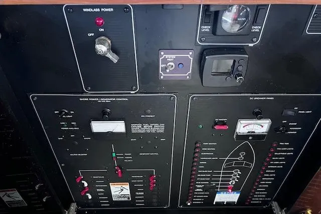 Slide: The Image of Control panel of a 1996 Bayliner 3388 Command Bridge Motoryacht with various switches and gauges. - 25