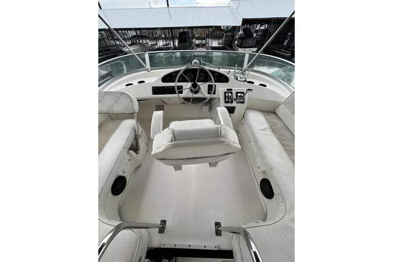 Slide: The Image of 1996 Bayliner 3388 Command Bridge Motoryacht cockpit with steering wheel and seating. - 36