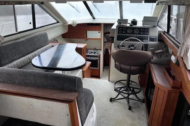Slide: The Image of 1996 Bayliner 3388 Command Bridge Motoryacht interior with helm, seating, and navigation equipment. - 4