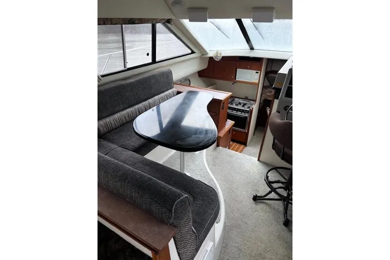 Slide: The Image of Interior of 1996 Bayliner 3388 Command Bridge Motoryacht with dining area and kitchen. - 5