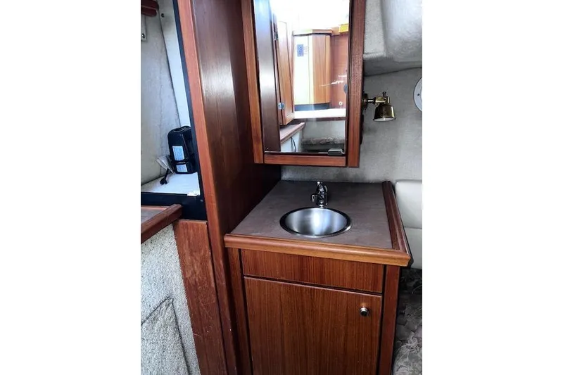 Slide: The Image of 1996 Bayliner 3388 Command Bridge Motoryacht interior with wooden cabinetry and compact sink. - 7