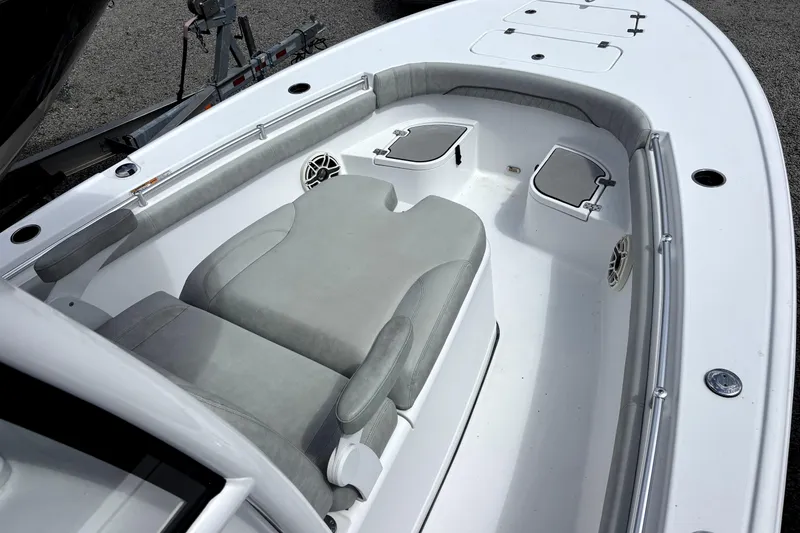 Slide: The Image of 2020 Sportsman Masters 267OE Bay Boat interior with cushioned seating and storage compartments. - 2