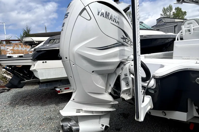 Slide: The Image of 2020 Sportsman Masters 267OE Bay Boat with Yamaha outboard engine, parked outdoors. - 4