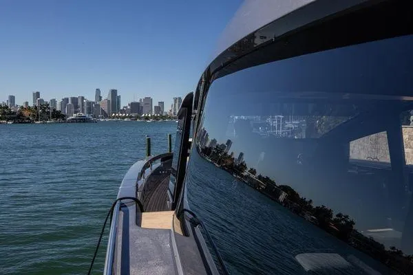 Slide: The Image of 2025 Pershing GTX 80 yacht with city skyline reflection on water. - 10