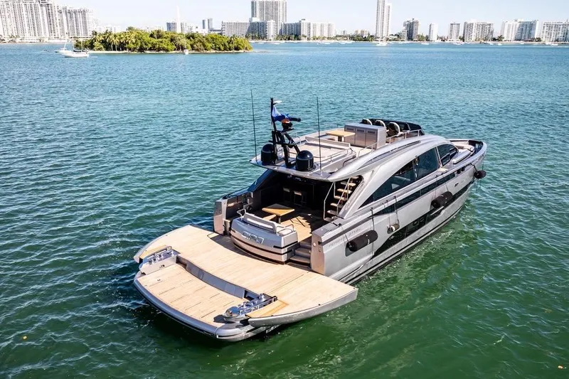 Slide: The Image of 2025 Pershing GTX 80 yacht cruising on a sunny day in a coastal city. - 2