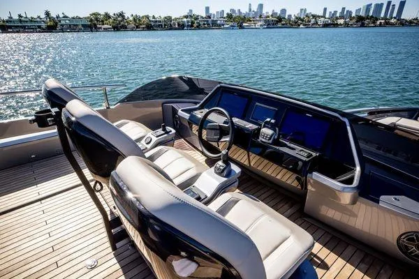 Slide: The Image of Helm of 2025 Pershing GTX 80 yacht with modern controls, overlooking serene waters. - 20