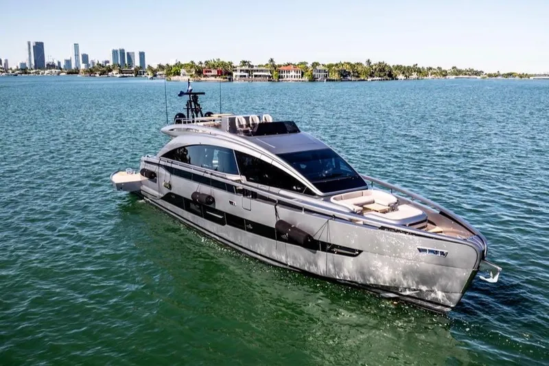 Slide: The Image of 2025 Pershing GTX 80 yacht cruising on a sunny day near a city skyline. - 3