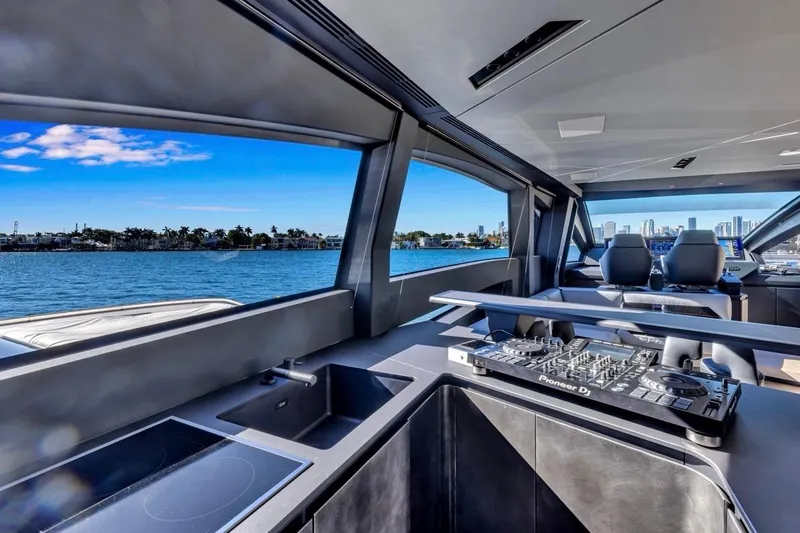 Slide: The Image of Luxurious interior of 2025 Pershing GTX 80 yacht with DJ equipment and scenic ocean view. - 34