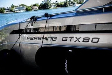 Slide: The Image of 2025 Pershing GTX 80 yacht docked by the water, showcasing sleek design. - 4