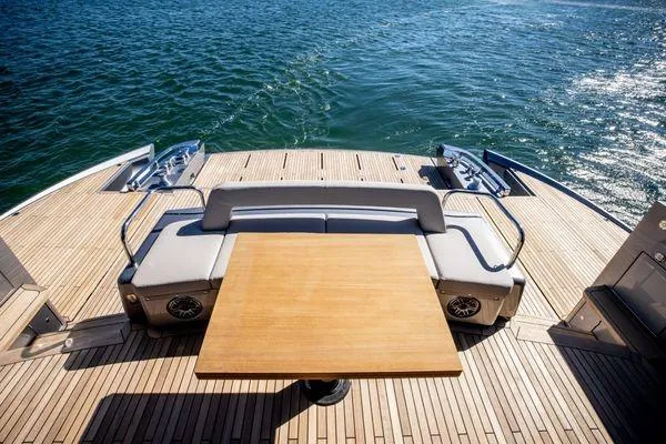 Slide: The Image of Luxury deck of 2025 Pershing GTX 80 yacht with wooden table and seating. - 8