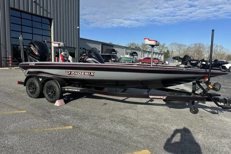 The Image of 2026 Phoenix 921 Elite X boat on trailer, parked outside a warehouse. - 0