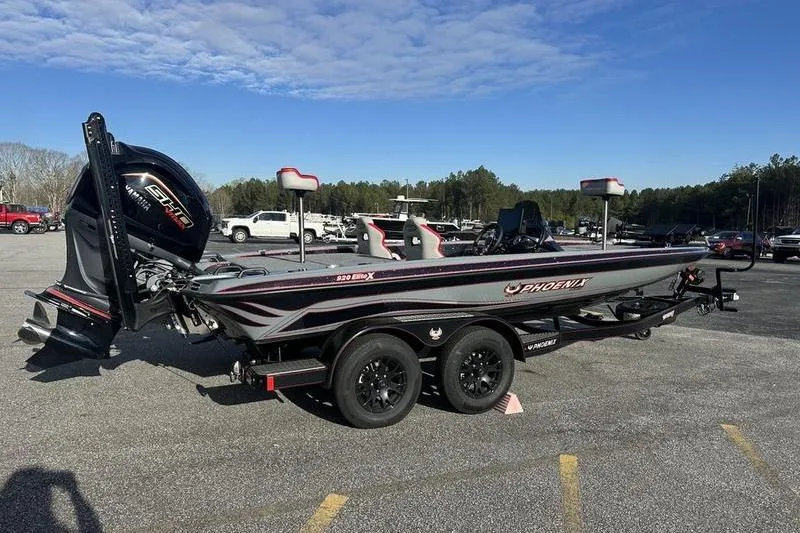 Slide: The Image of 2026 Phoenix 921 Elite X boat on trailer in parking lot, under clear blue sky. - 3